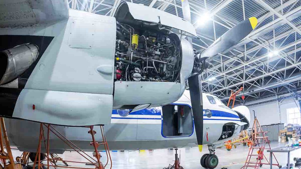 Airplane undergoing regular maintenance in hangar.