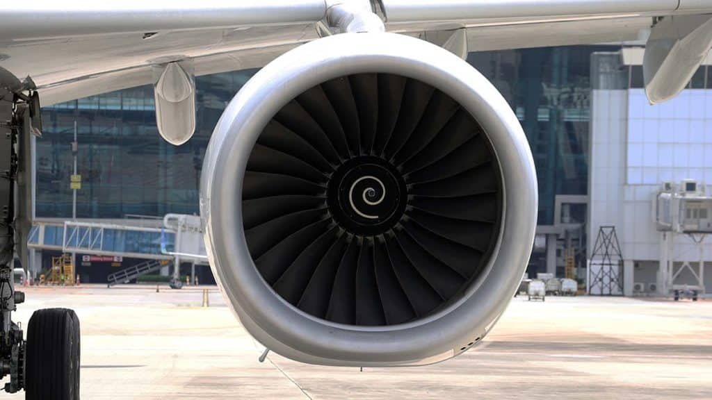 A close up of an aircraft engine sitting on-wing.